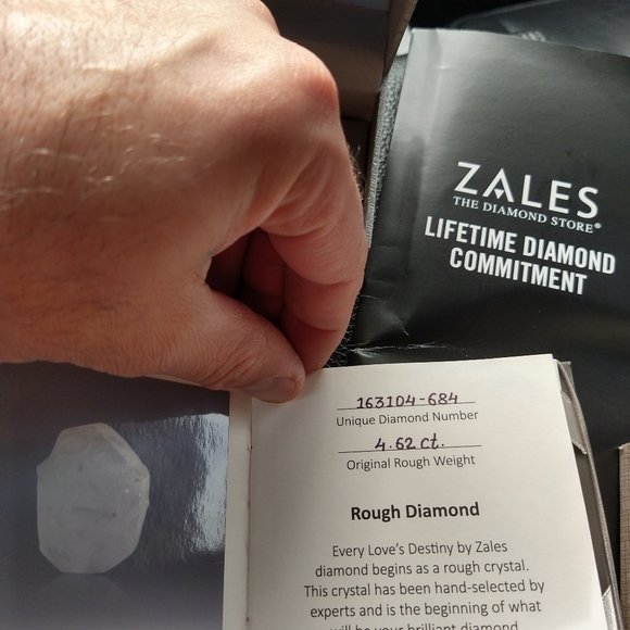 An engagement ring and man's wedding band . - Picture 2 of 10